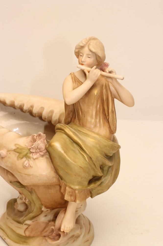 AN ART NOUVEAU ROYAL DUX BISQUE PORCELAIN FIGURAL CENTREPIECE modelled as a maiden playing a flute Image