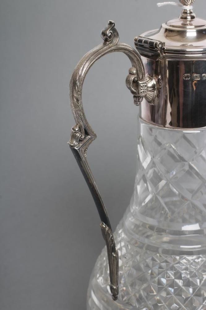 A SILVER MOUNTED CLEAR GLASS CLARET JUG Image