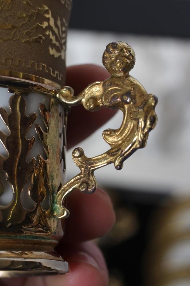 A SET OF SIX J. POUYAT LIMOGES PORCELAIN CANS AND SAUCERS with raised and burnished foliate gilded Image