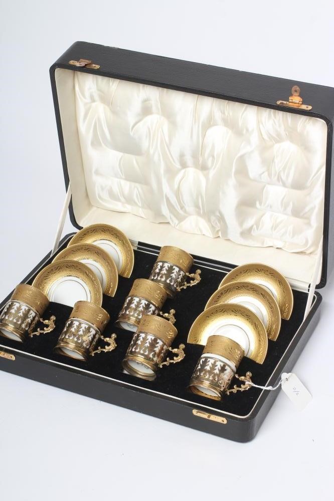 A SET OF SIX J. POUYAT LIMOGES PORCELAIN CANS AND SAUCERS with raised and burnished foliate gilded Image