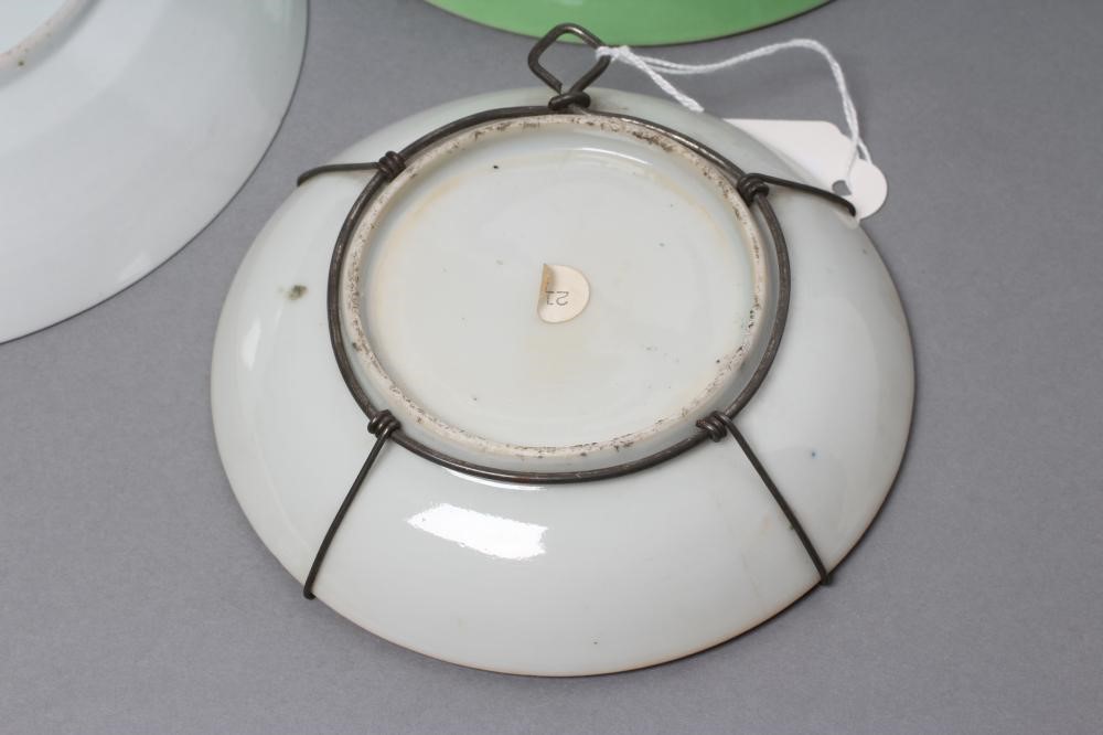 A CHINESE PORCELAIN FAMILLE ROSE SAUCER painted with three figures in a garden within a blue and Image