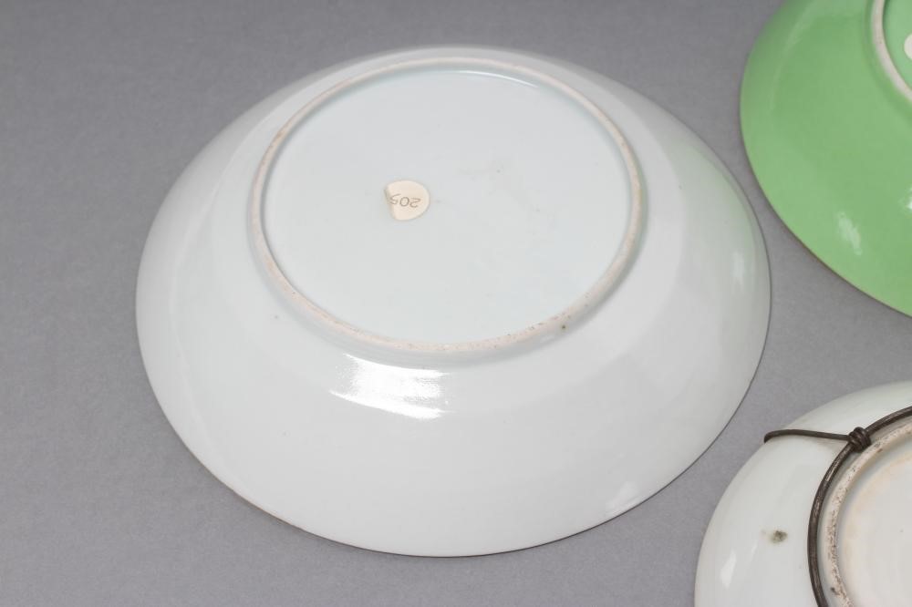 A CHINESE PORCELAIN FAMILLE ROSE SAUCER painted with three figures in a garden within a blue and Image