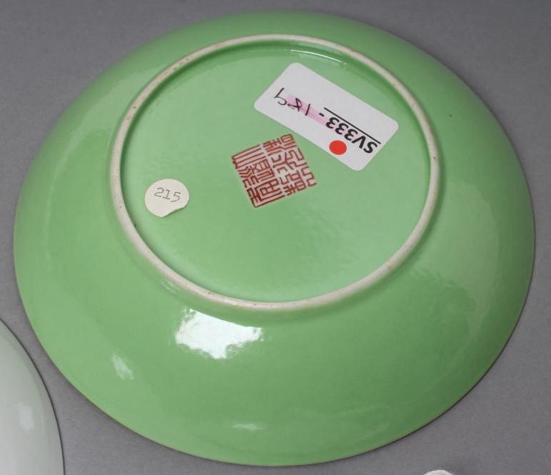 A CHINESE PORCELAIN FAMILLE ROSE SAUCER painted with three figures in a garden within a blue and Image