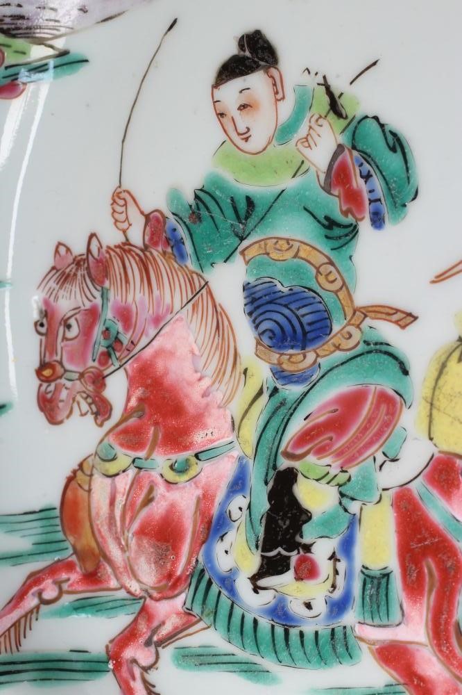 A SET OF THREE CHINESE PORCELAIN FAMILLE ROSE PLATES painted with a horseman fording a stream Image