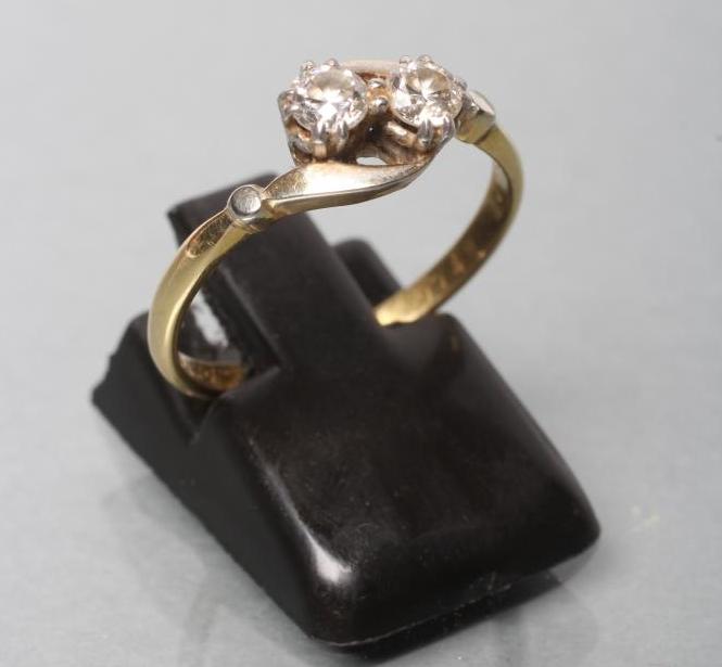 A TWO STONE DIAMOND CROSSOVER RING Image