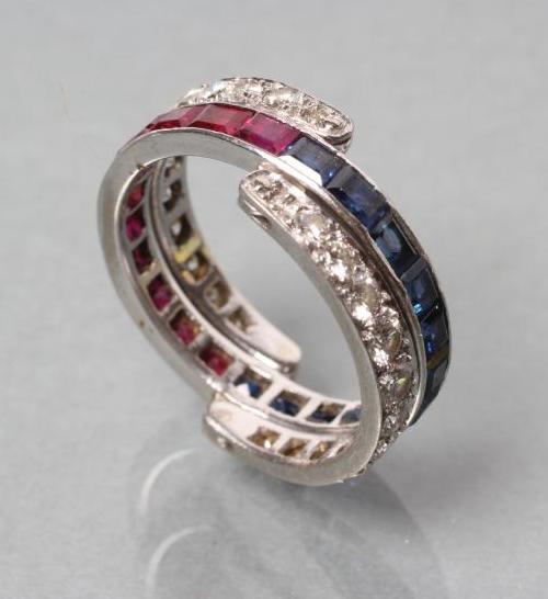 A DIAMOND, RUBY AND SAPPHIRE ETERNITY RING Image