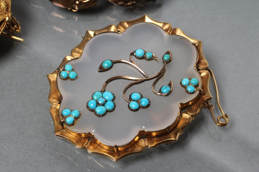 THREE VICTORIAN BROOCHES comprising a boss centred by an amethyst coloured cabochon within coral Image