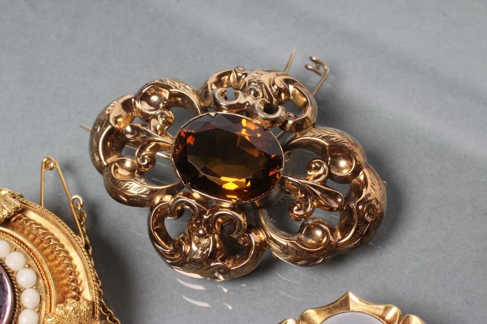 THREE VICTORIAN BROOCHES comprising a boss centred by an amethyst coloured cabochon within coral Image