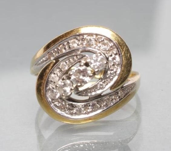 A DIAMOND DRESS RING diagonally set with three stones to an open whorl pave set with numerous Image