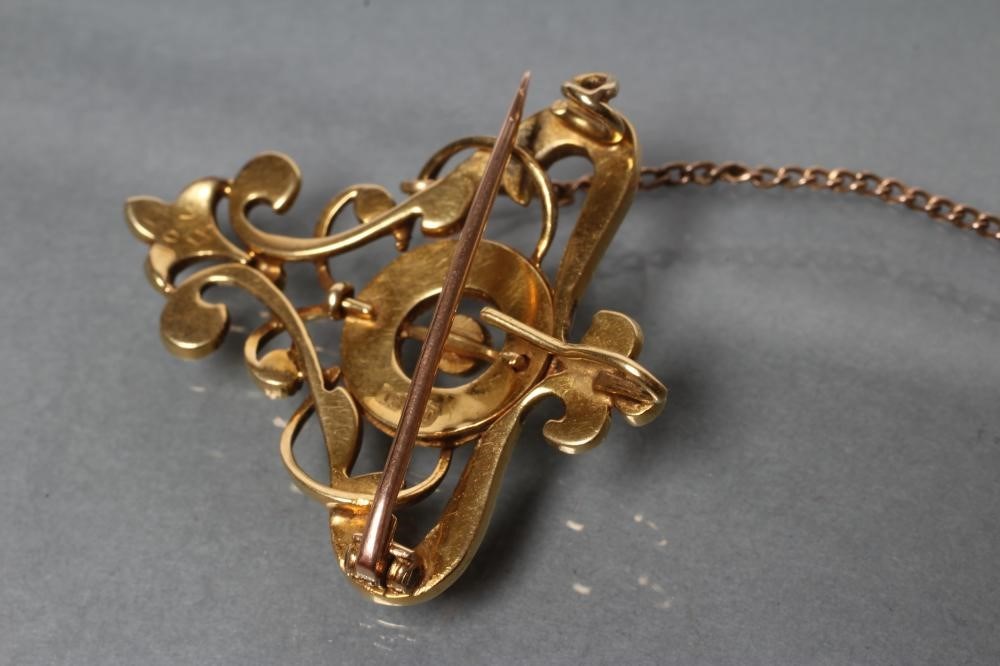 An edwardian seed pearl pendant/brooch of open shield form centred by a ...