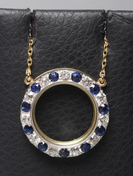 A SAPPHIRE AND DIAMOND CIRCLET PENDANT pave set with eleven sapphires and diamonds fixed to a plain Image