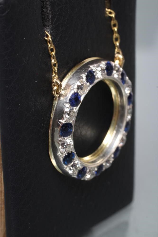 A SAPPHIRE AND DIAMOND CIRCLET PENDANT pave set with eleven sapphires and diamonds fixed to a plain Image