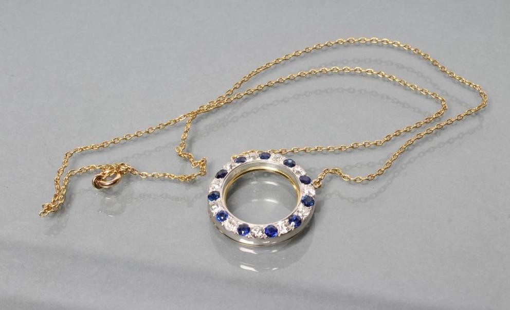 A SAPPHIRE AND DIAMOND CIRCLET PENDANT pave set with eleven sapphires and diamonds fixed to a plain Image