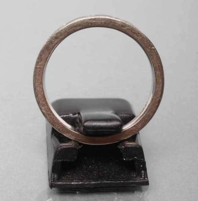 A WHITE WEDDING RING set with five small brilliant cut diamonds Image