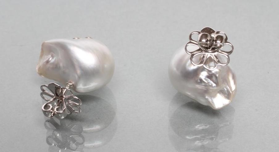A LARGE PAIR OF BAROQUE PEARL EAR STUDS Image