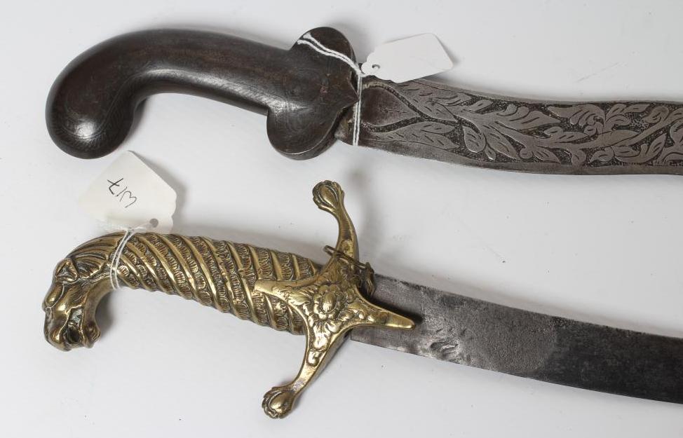 A SHAMSHIR with 26 3/4" curved blade and brass hilt with scalloped grip and lion head pommel Image