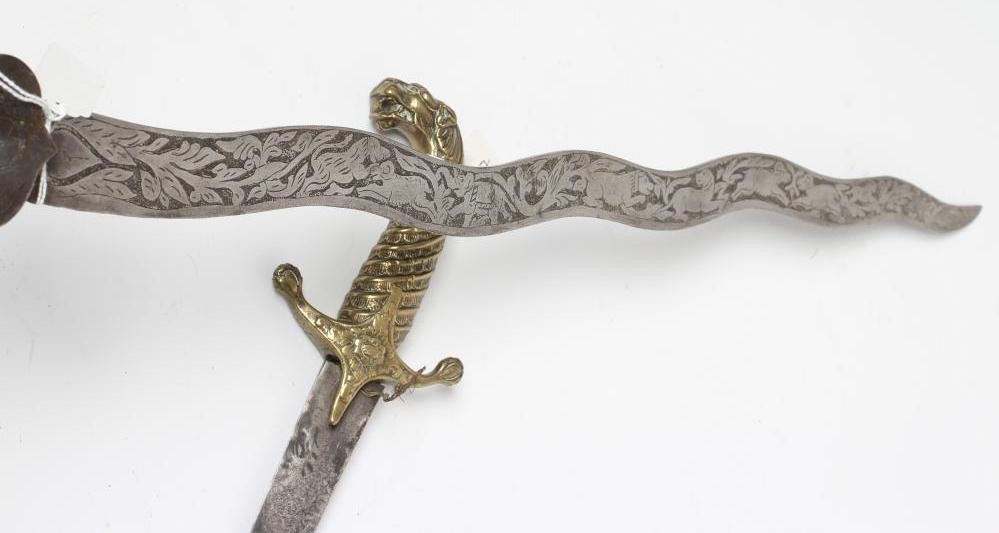 A SHAMSHIR with 26 3/4" curved blade and brass hilt with scalloped grip and lion head pommel Image