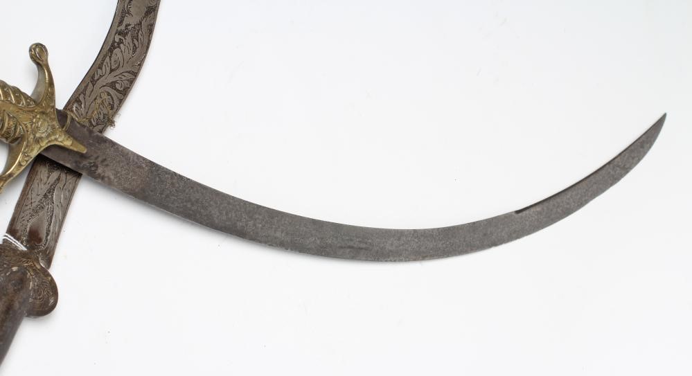 A SHAMSHIR with 26 3/4" curved blade and brass hilt with scalloped grip and lion head pommel Image