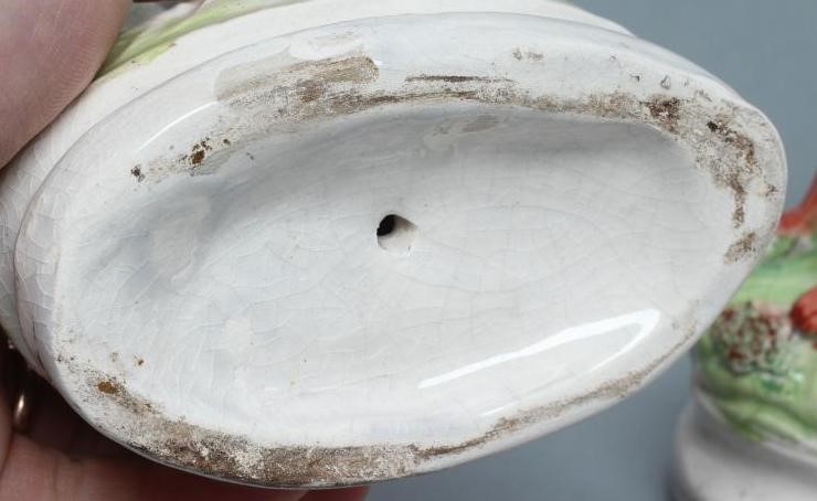 A PAIR OF LATE VICTORIAN STAFFORDSHIRE POTTERY SEATED GREYHOUNDS with free standing fore-legs and Image