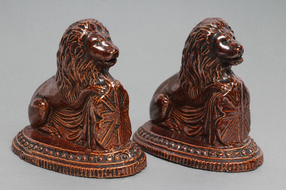 A PAIR OF BRAMPTON TYPE BROWN SALTGLAZE STONEWARE LIONS Image