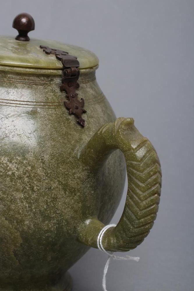 AN INDIAN CARVED AND POLISHED GREEN STONE TEAPOT of globular form with loop handle Image