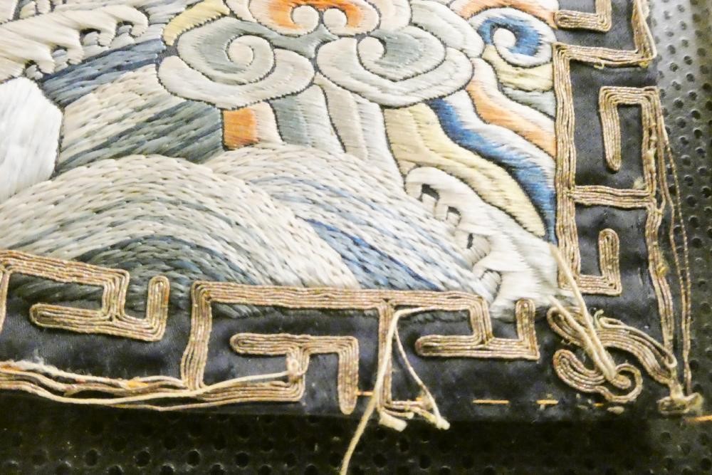 A PAIR OF CHINESE SILK SQUARE PANELS embroidered in coloured silks on a dark navy ground Image