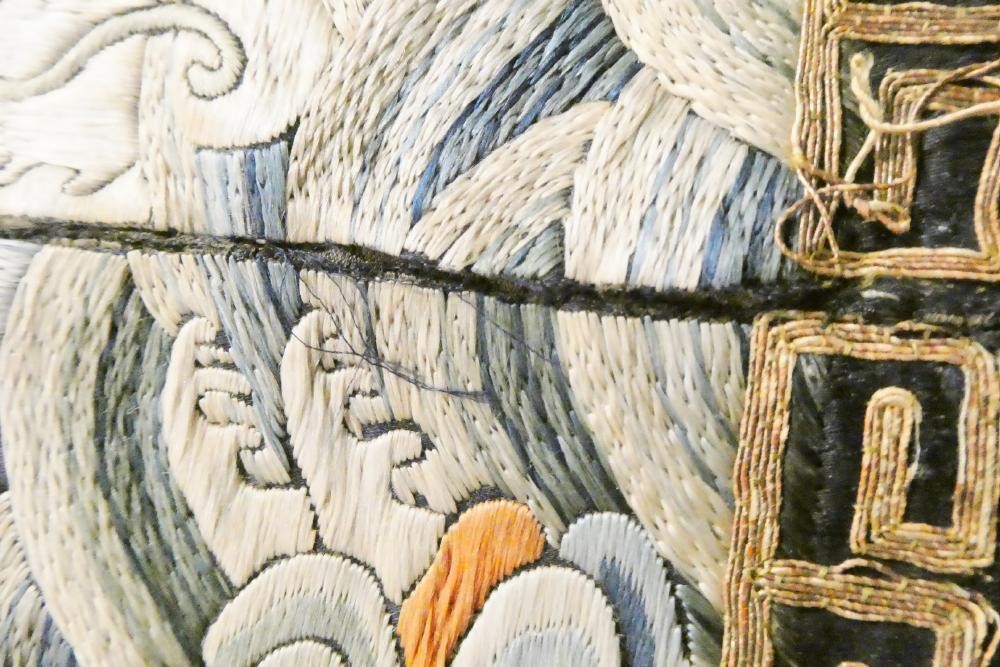 A PAIR OF CHINESE SILK SQUARE PANELS embroidered in coloured silks on a dark navy ground Image