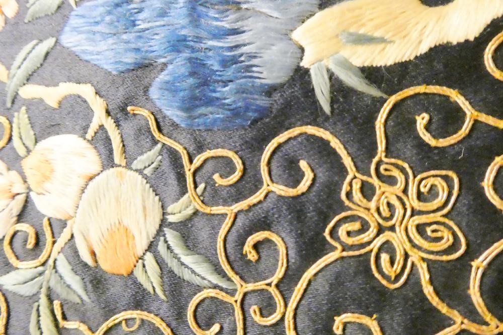 A PAIR OF CHINESE SILK SQUARE PANELS embroidered in coloured silks on a dark navy ground Image