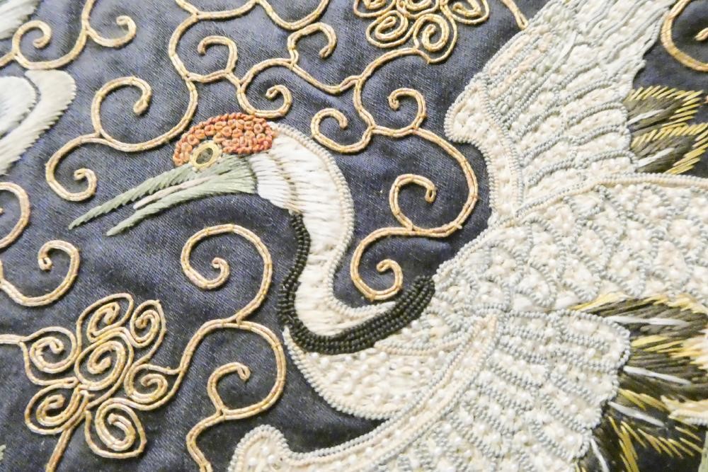 A PAIR OF CHINESE SILK SQUARE PANELS embroidered in coloured silks on a dark navy ground Image