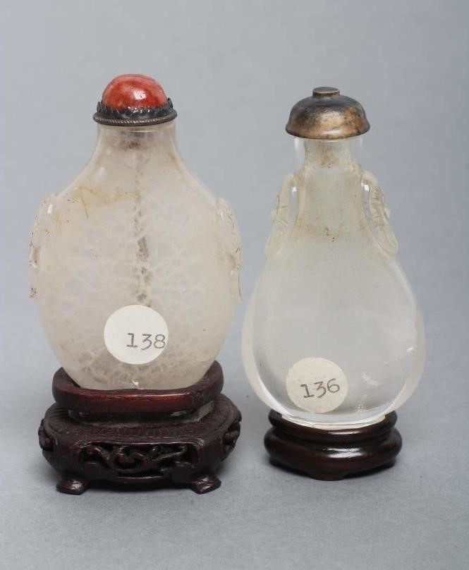 A CHINESE WHITE OPAQUE CRYSTAL SNUFF BOTTLE carved in relief with two mask ring handles Image