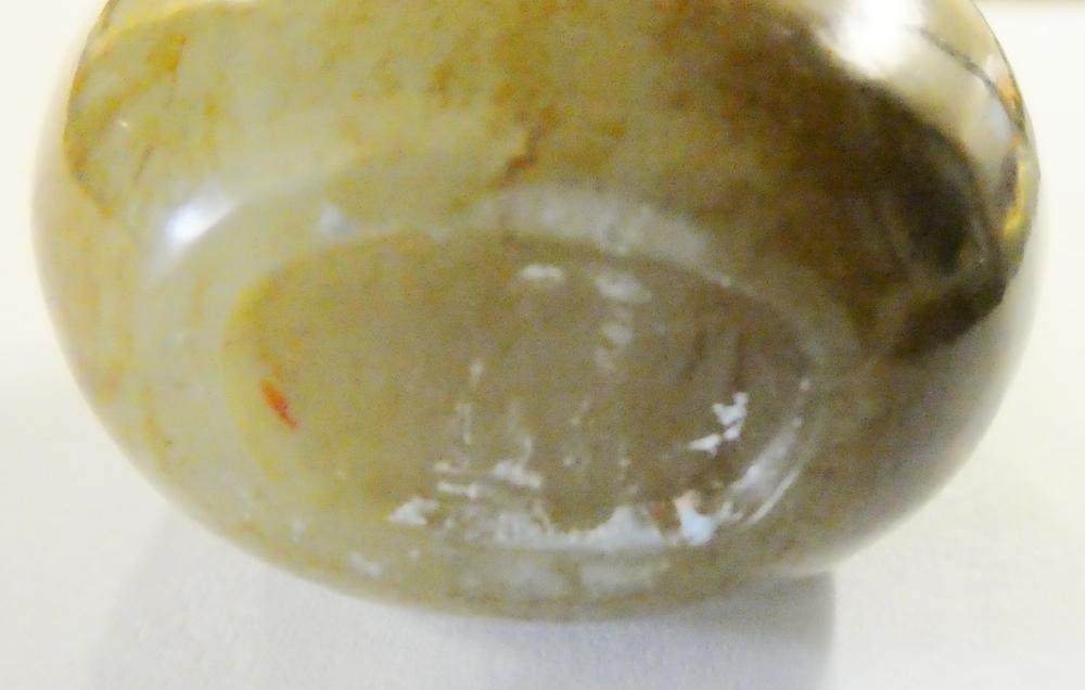 A CHINESE POLISHED OLIVE GREEN JADEITE SNUFF BOTTLE with amber/brown mottling Image