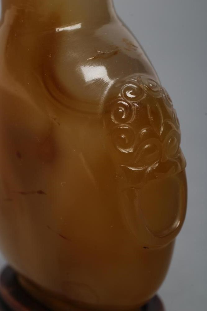 A CHINESE HONEY AGATE SNUFF BOTTLE with grey and amber cloud effect Image