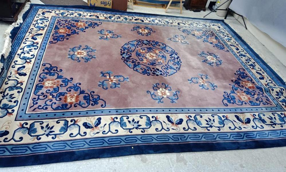 A CHINESE WASHED AND FRINGED CARPET Image