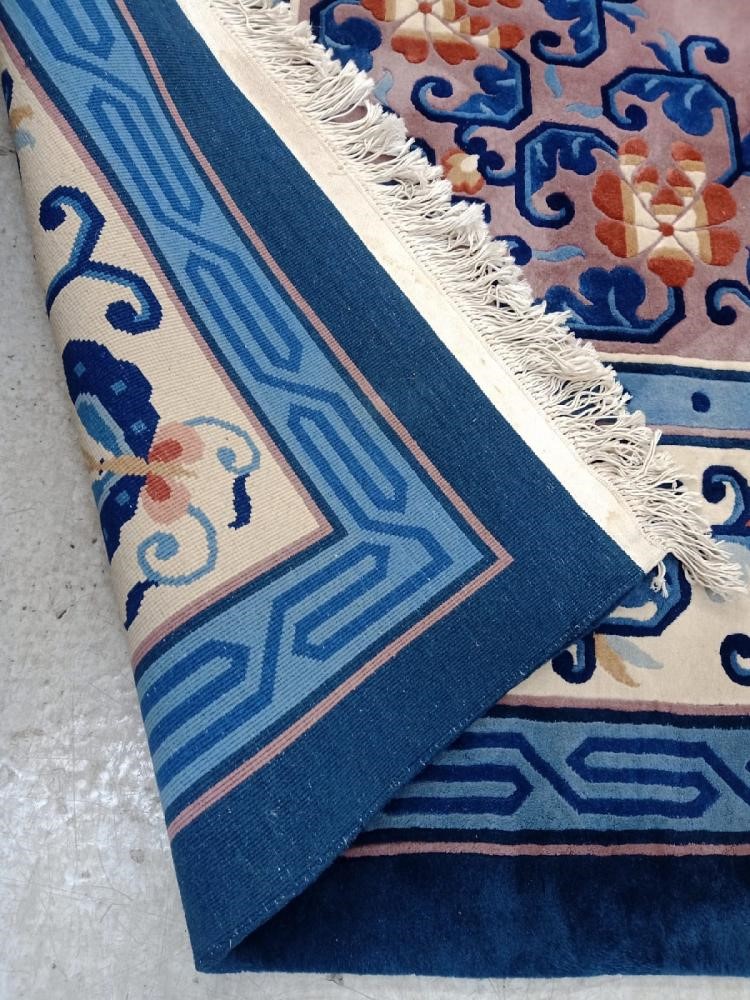 A CHINESE WASHED AND FRINGED CARPET Image