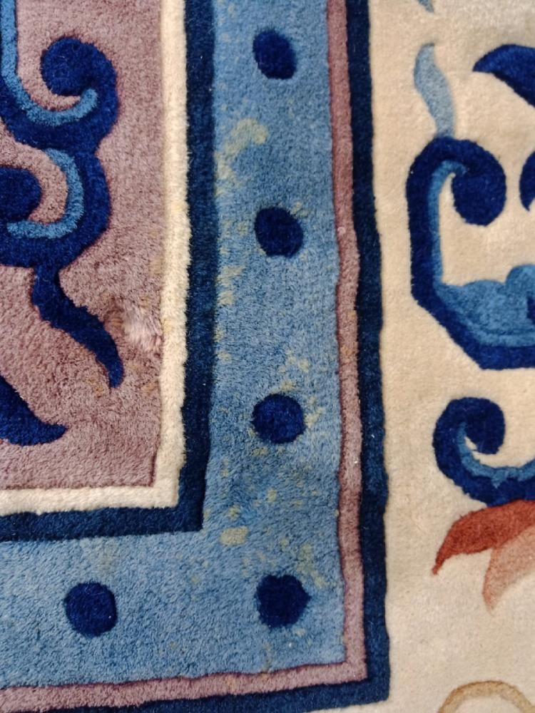 A CHINESE WASHED AND FRINGED CARPET Image