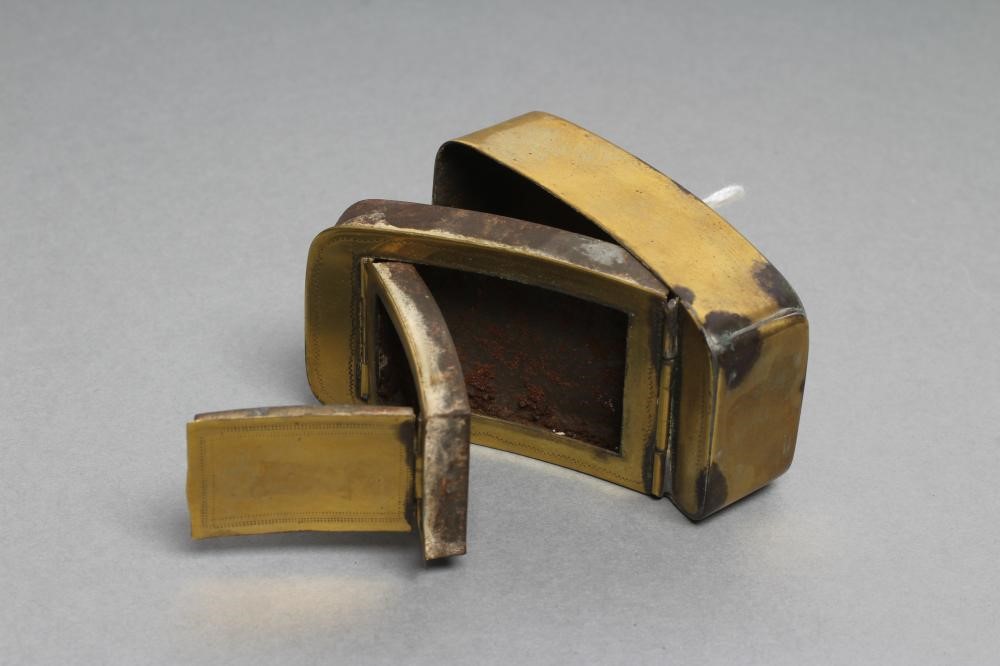 A GEORGIAN BRASS DOUBLE HINGED SNUFF/VESTA CASE of plain rounded oblong slightly concave form with Image