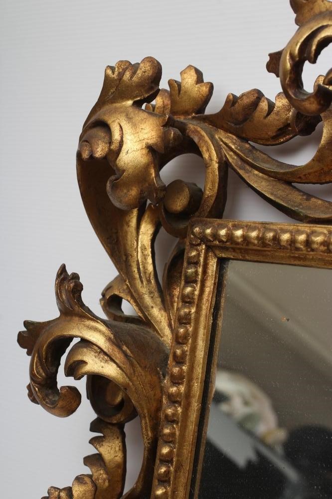 A CARVED GILT WOOD WALL MIRROR Image