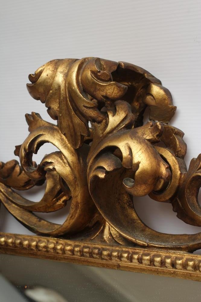 A CARVED GILT WOOD WALL MIRROR Image