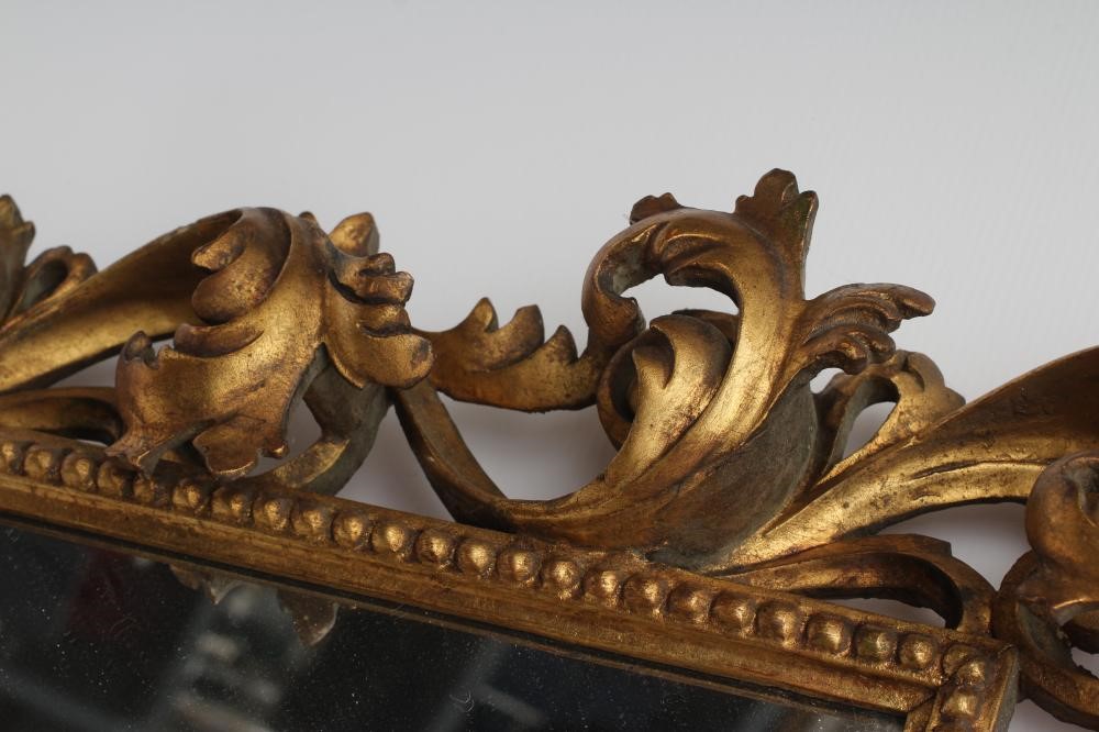 A CARVED GILT WOOD WALL MIRROR Image