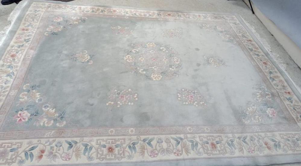 A CHINESE WASHED AND FRINGED CARPET Image