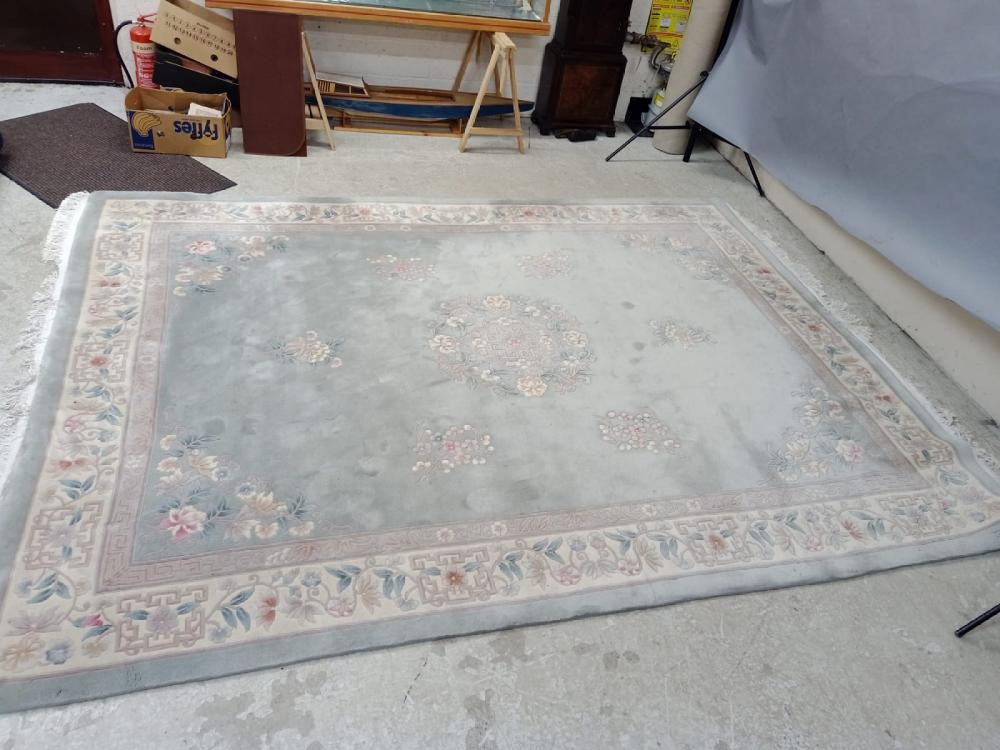 A CHINESE WASHED AND FRINGED CARPET Image