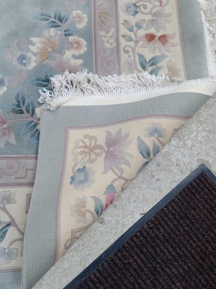 A CHINESE WASHED AND FRINGED CARPET Image