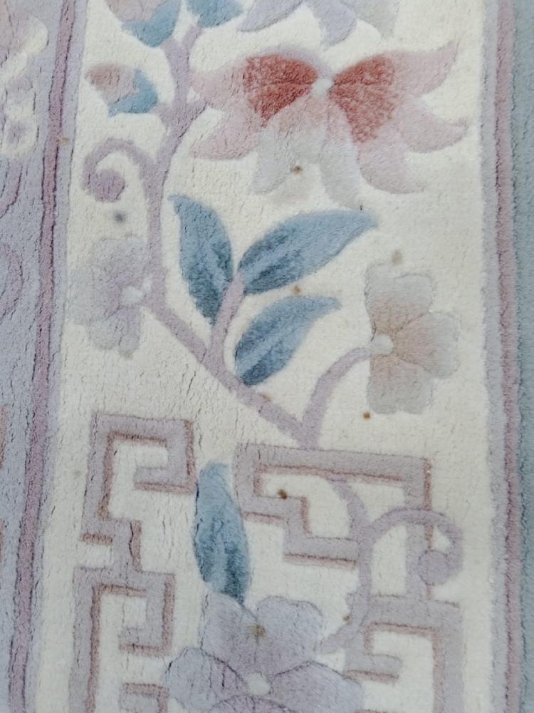 A CHINESE WASHED AND FRINGED CARPET Image