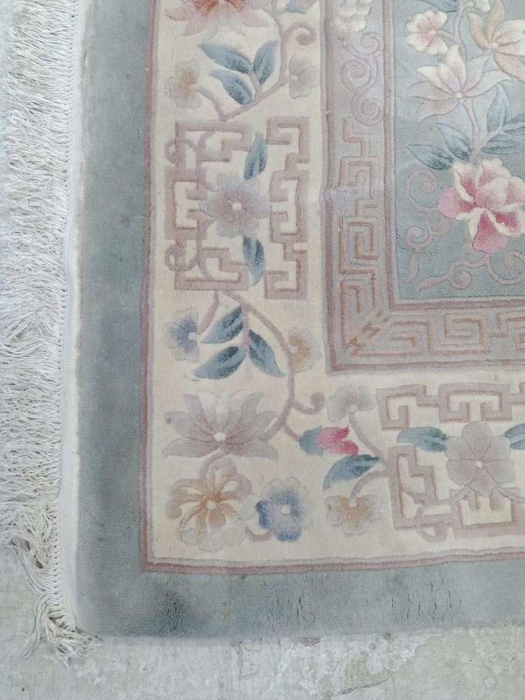 A CHINESE WASHED AND FRINGED CARPET Image