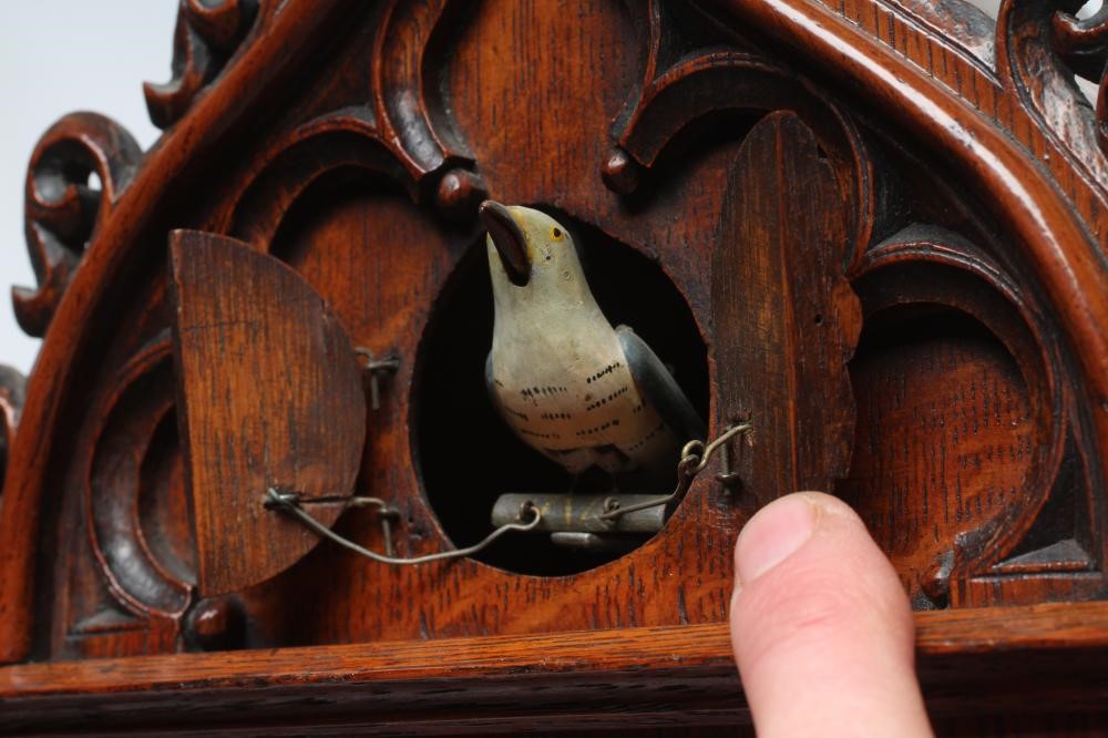 AN OAK CASED CUCKOO TABLE CLOCK Image