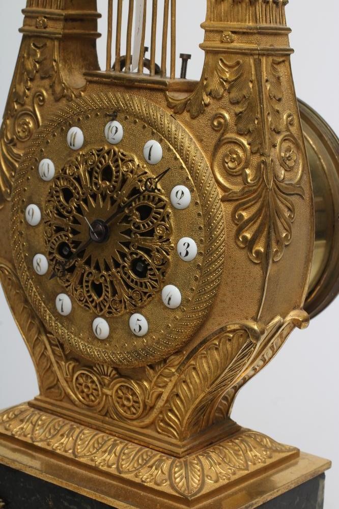 A LOUIS XVI STYLE GILT METAL LYRE MANTEL CLOCK Image