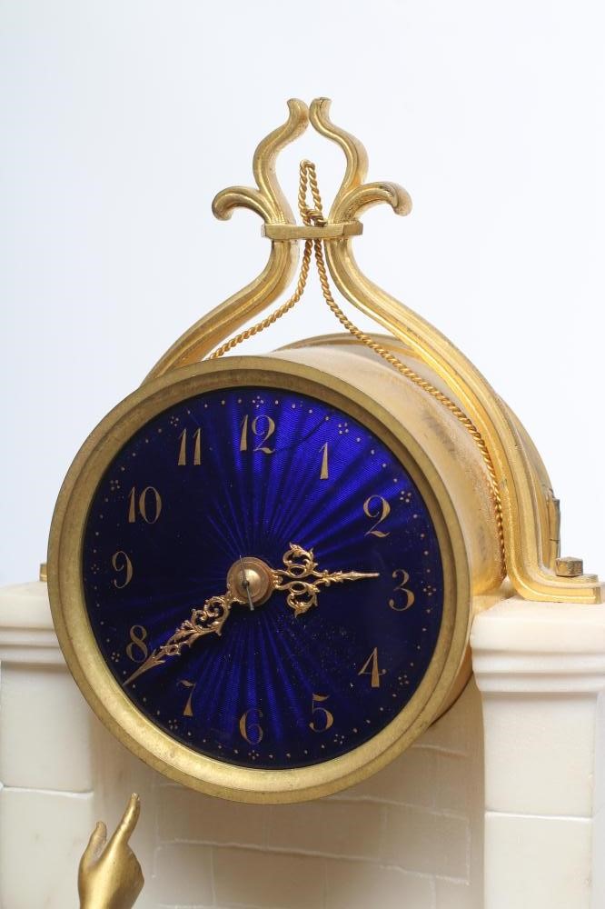 A GILT METAL AND WHITE MARBLE CASED MANTEL CLOCK Image