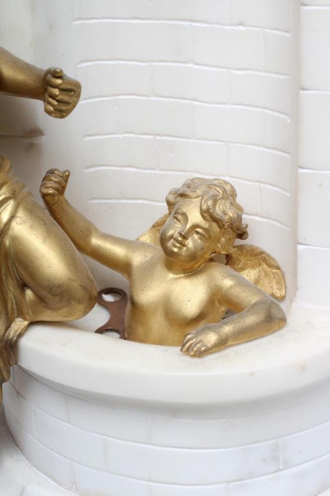 A GILT METAL AND WHITE MARBLE CASED MANTEL CLOCK Image