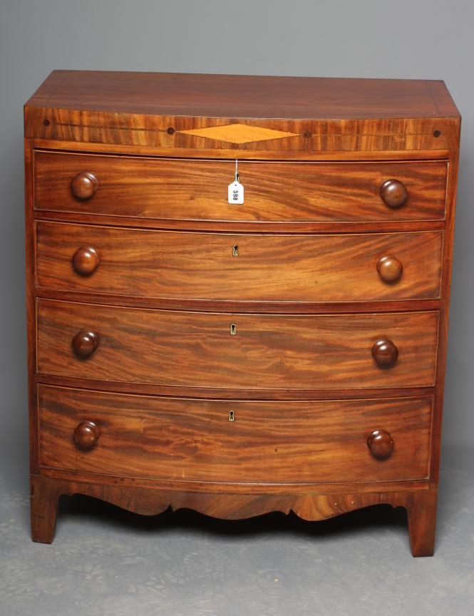 A REGENCY MAHOGANY BOW FRONT CHEST of four graduated drawers with turned wood handles Image