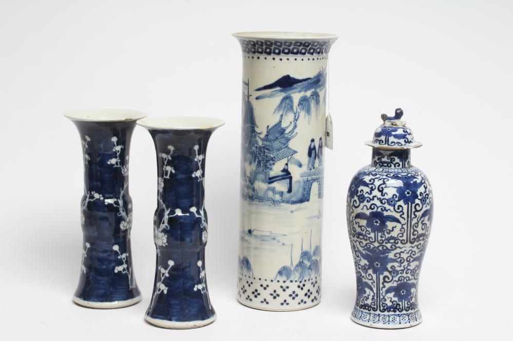 A PAIR OF CHINESE PORCELAIN GU VASES painted in underglaze blue with prunus on a dark shaded ground Image